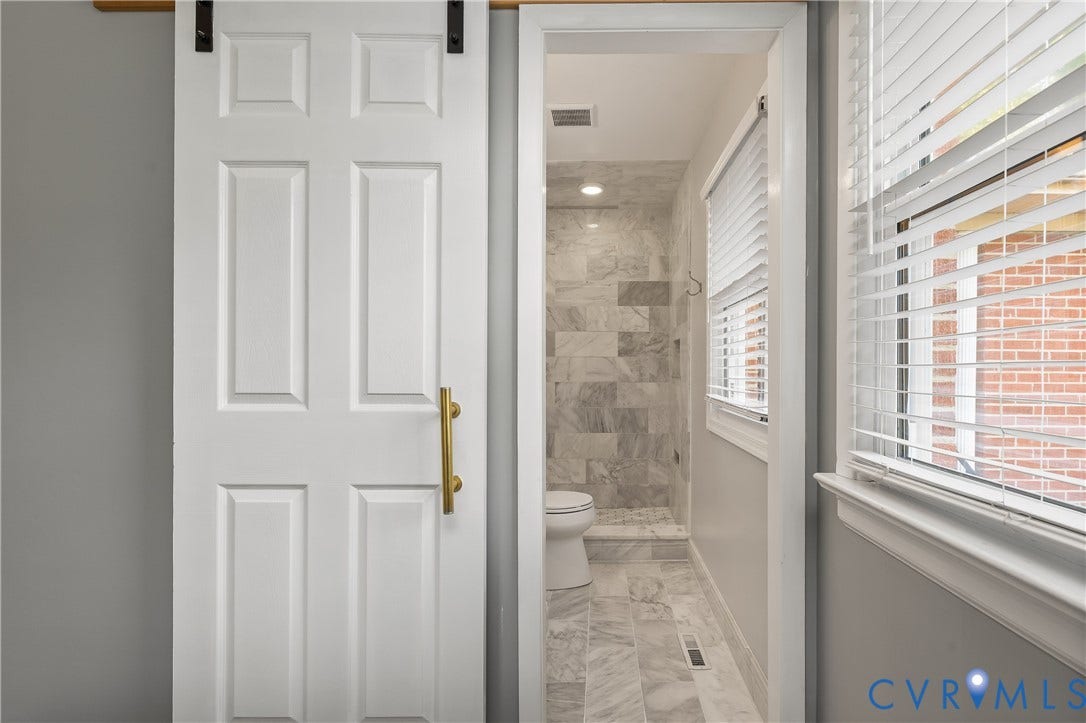 300 Gunby Drive, Henrico, VA 23229 White paneled barn door with brass hardware
