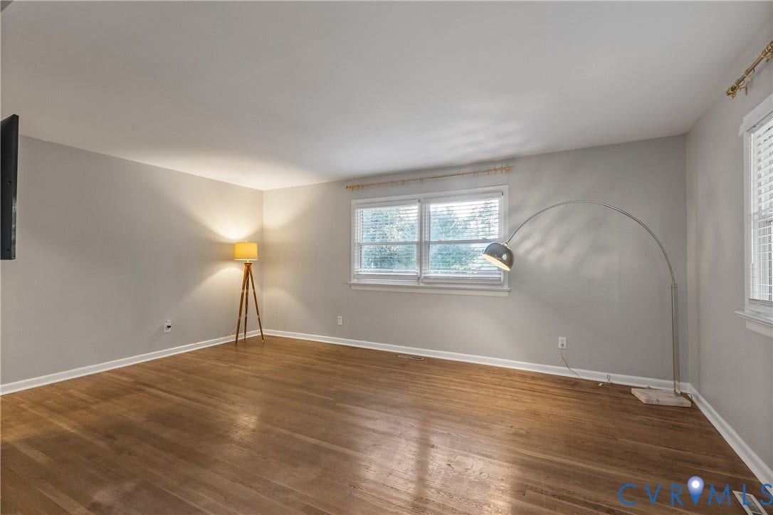 300 Gunby Drive, Henrico, VA 23229 Hardwood flooring, light gray wall paint, white trim, and multiple windows with blinds