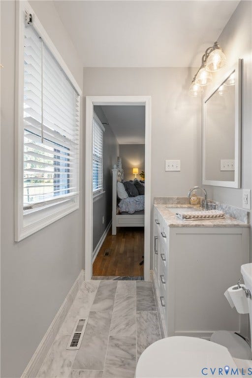 300 Gunby Drive, Henrico, VA 23229 White vanity with a stone countertop, under-mount sink, and chrome faucet