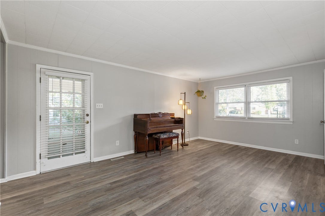 300 Gunby Drive, Henrico, VA 23229 Spacious room featuring wood-finish flooring, light gray walls, white trim, and multiple windows