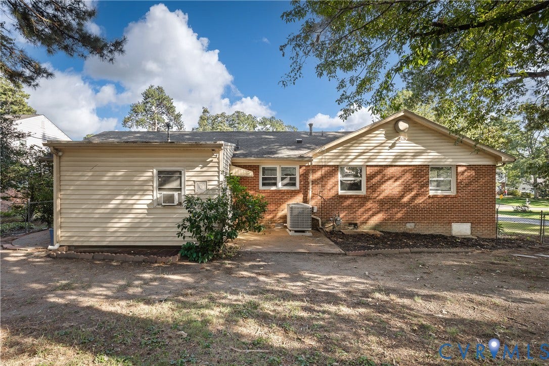 300 Gunby Drive, Henrico, VA 23229 Exterior featuring brick and horizontal siding, multiple windows, and a paved patio area