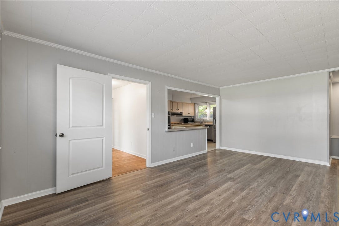 300 Gunby Drive, Henrico, VA 23229 Wood-finish flooring throughout, light gray wall paneling, and an arched panel interior door