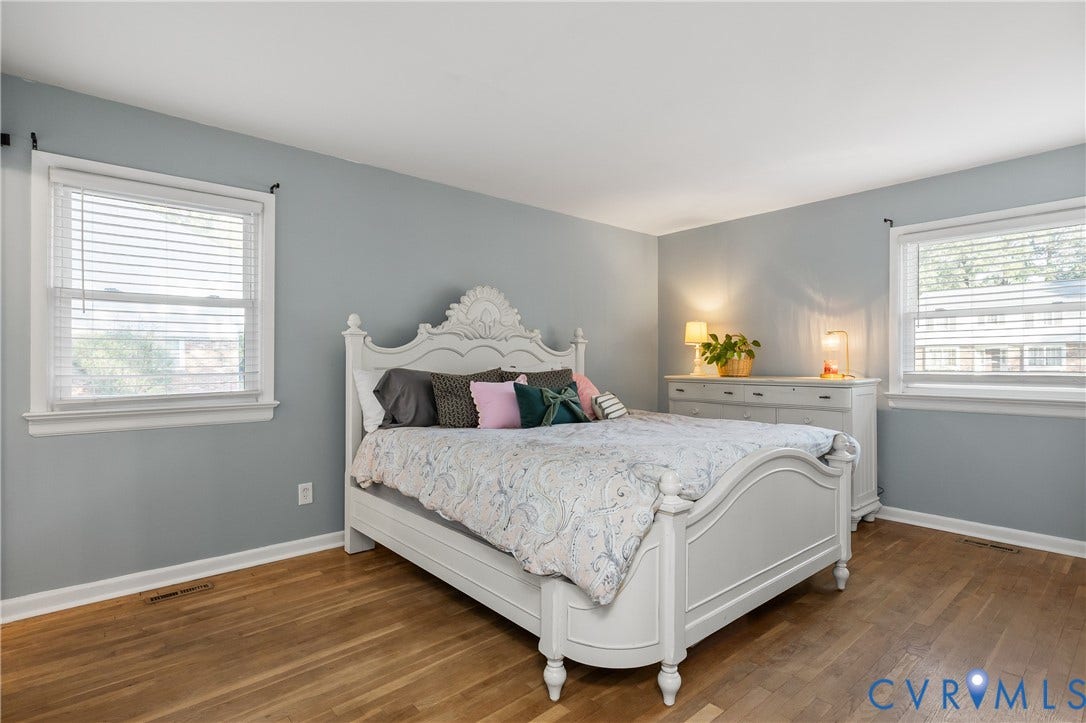 300 Gunby Drive, Henrico, VA 23229 Wood-finish flooring, two windows with white trim, and light blue wall paint