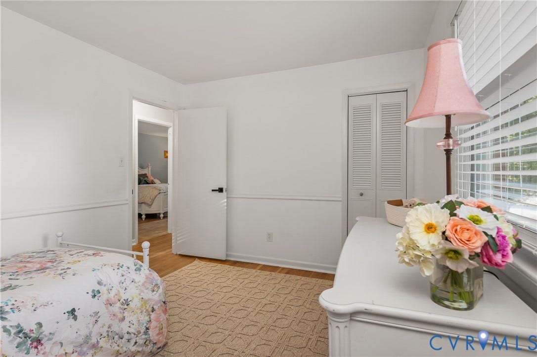 300 Gunby Drive, Henrico, VA 23229 Room featuring wood-finish flooring, white walls with chair rail molding, a white louvered bifold closet door, and a window with horizontal blinds