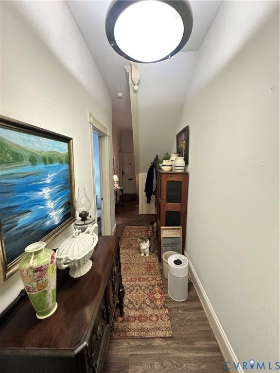 Recessed lighting illuminates wood-finish flooring