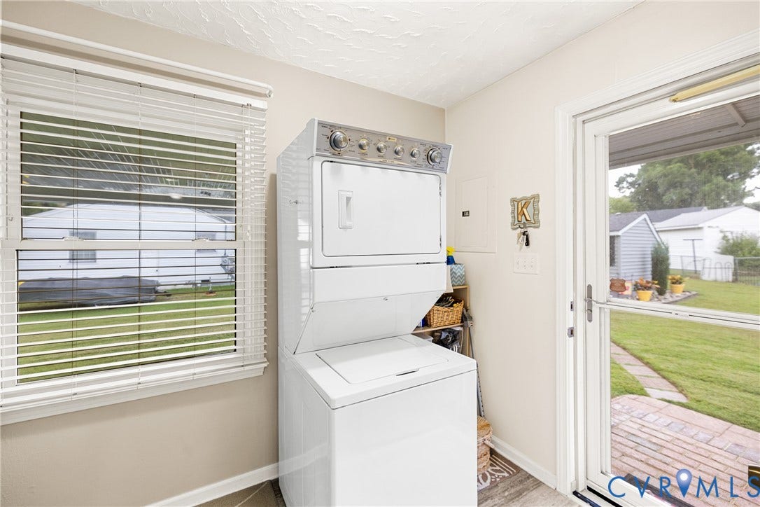 822 Old Town Drive, Colonial Heights, VA 23834 Laundry area featuring a stackable washer and dryer, a window with blinds, and a glass-paneled exterior door