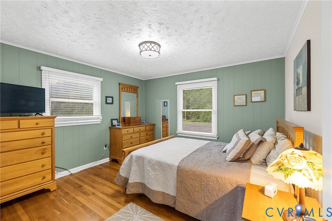 822 Old Town Drive, Colonial Heights, VA 23834 Hardwood flooring, painted paneled walls, ceiling-mounted light fixture, and multiple windows