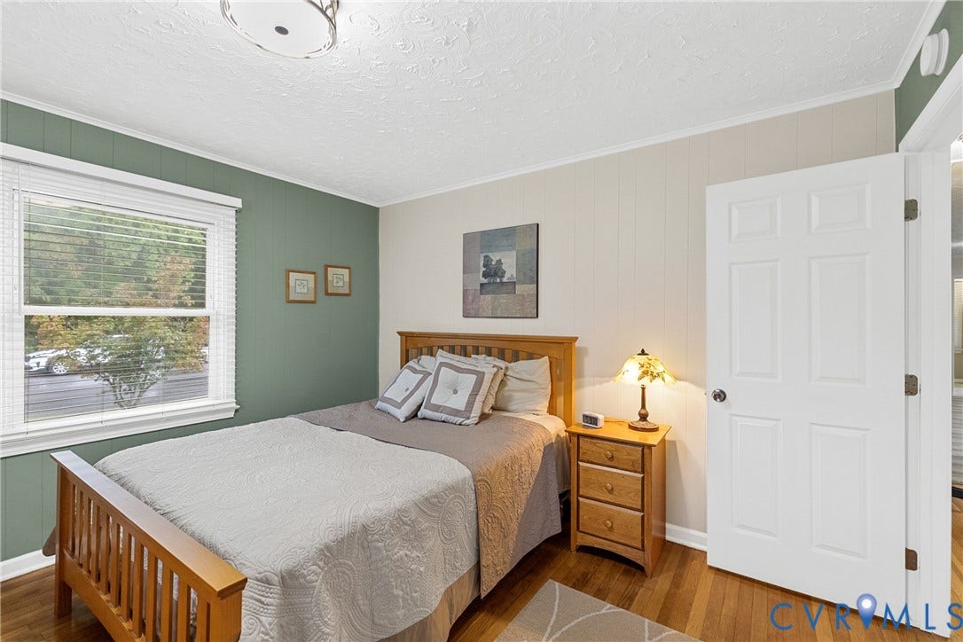 822 Old Town Drive, Colonial Heights, VA 23834 Hardwood flooring, painted paneled walls, white trim, and a ceiling-mounted light fixture