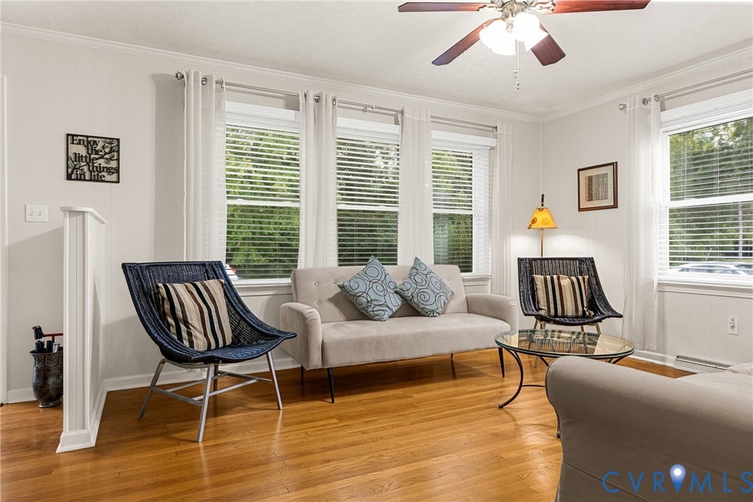 822 Old Town Drive, Colonial Heights, VA 23834 Hardwood flooring, multiple windows with blinds, ceiling fan with light fixture, white wall paneling, and crown molding