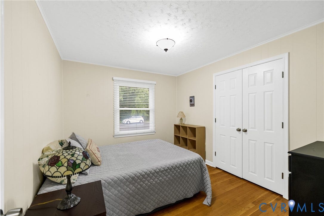 822 Old Town Drive, Colonial Heights, VA 23834 Wood-finish flooring, neutral wall paneling, and a ceiling-mounted light fixture