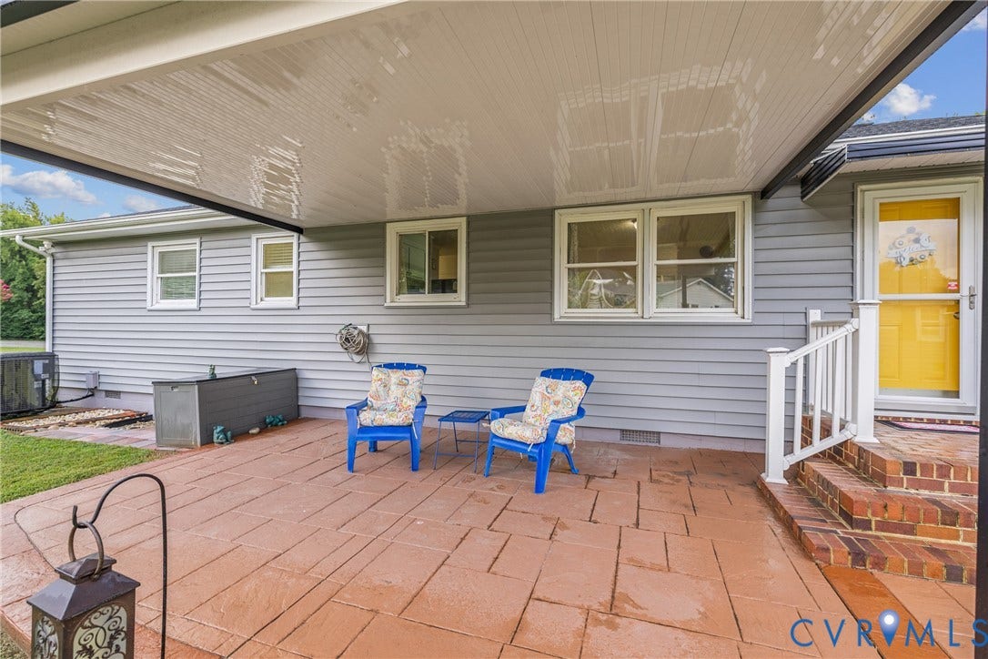 822 Old Town Drive, Colonial Heights, VA 23834 Expansive covered patio featuring stamped concrete flooring, brick steps, and a white railing