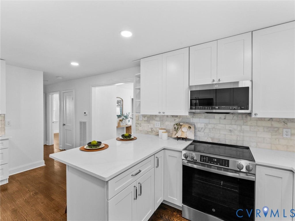 White shaker cabinetry, recessed lighting, stainless steel appliances, white countertops, and subway tile backsplash