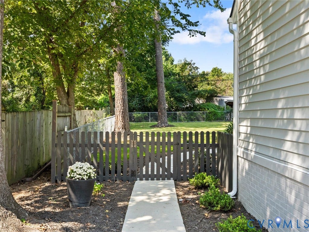 Exterior siding in a neutral tone, complemented by a white gutter system