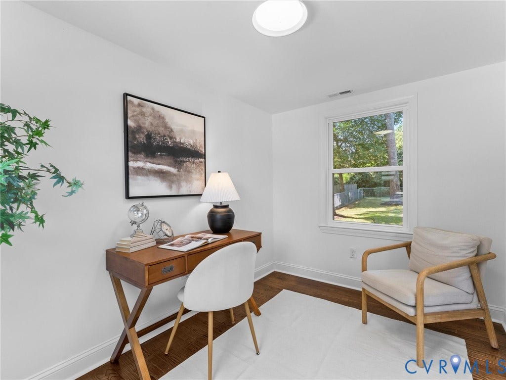Hardwood flooring, painted walls, white trim, recessed light, and a window providing natural illumination