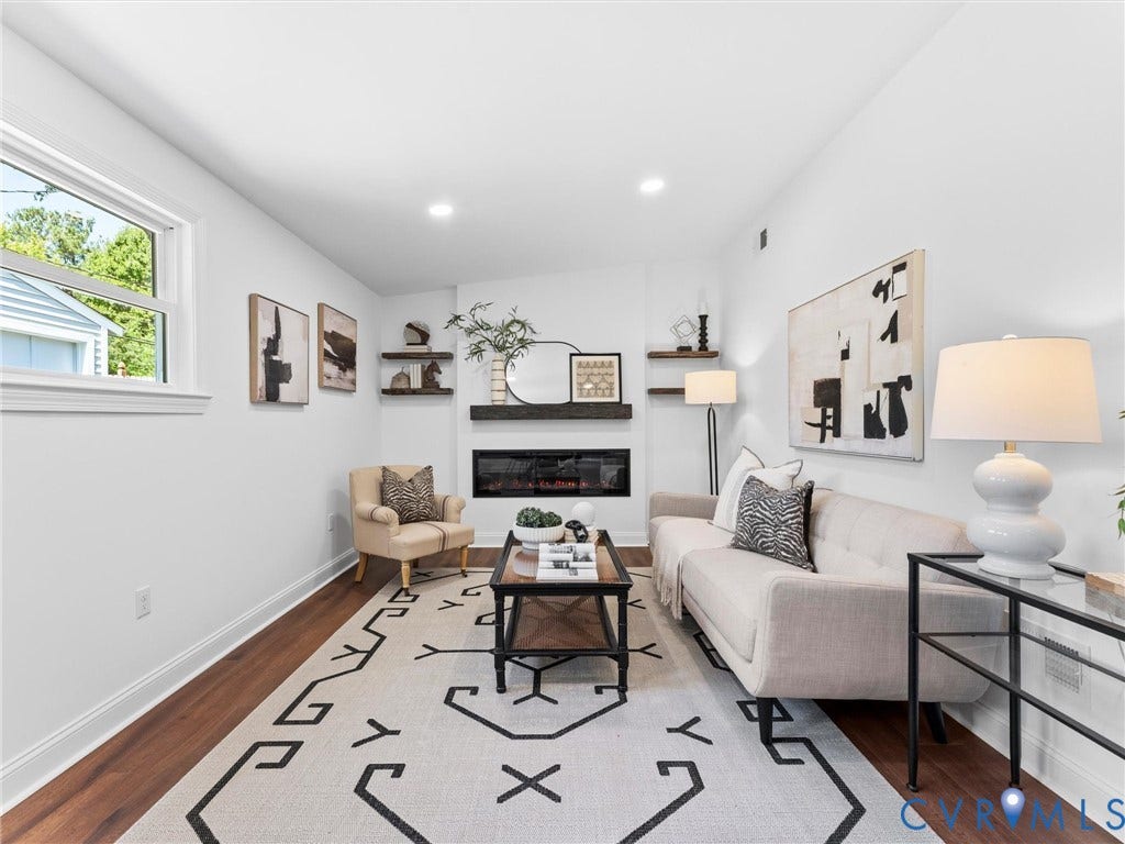 Wood-finish flooring, recessed lighting, and a built-in electric fireplace