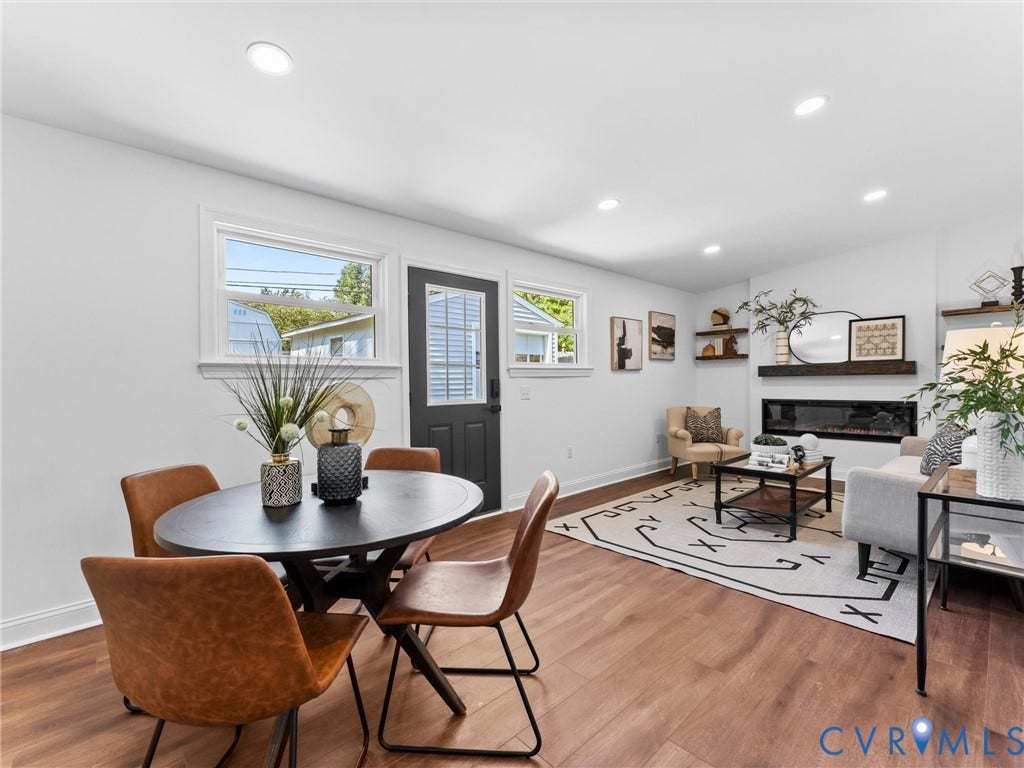 Recessed lighting, wood-finish flooring, and a built-in electric fireplace with a wood mantle