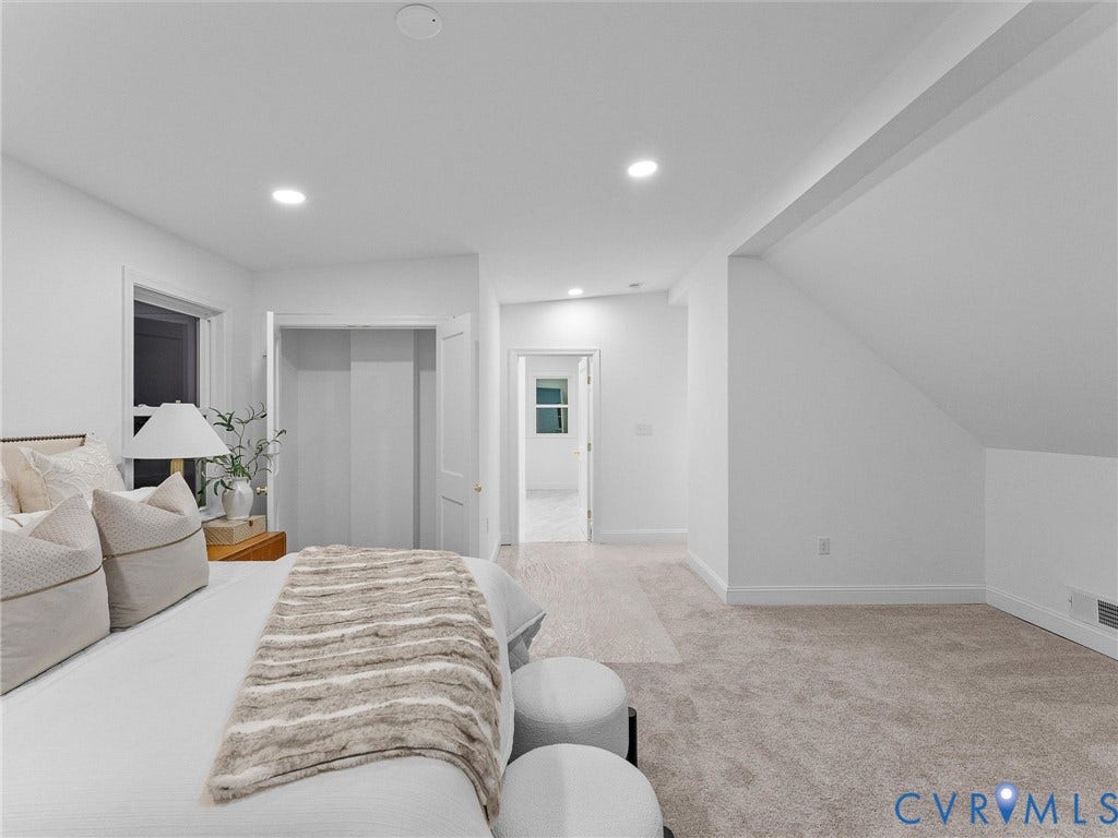 Recessed lighting, window with trim, built-in closet with double doors, sloped ceiling, and plush carpeting