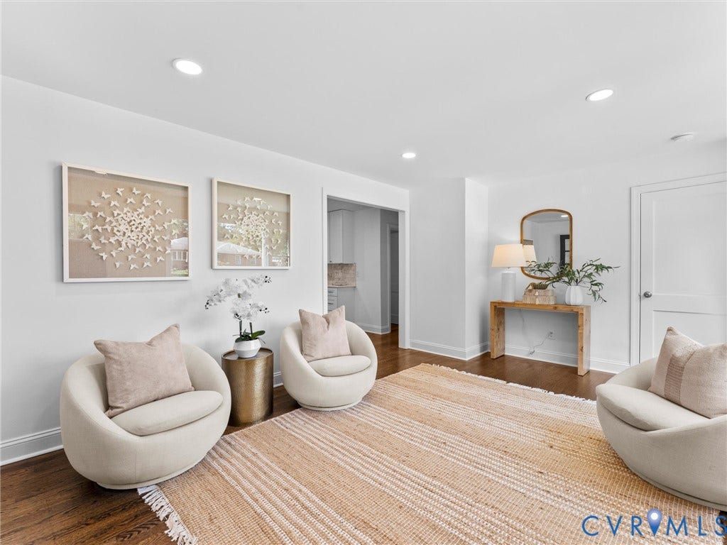 Recessed ceiling lighting, wood-finish flooring, white wall finishes, and a white interior door