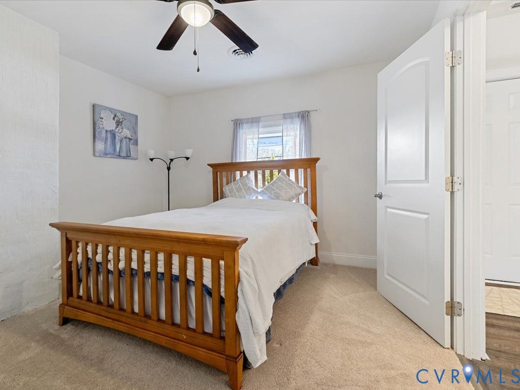 2021 Venable Street, Union Hill, Richmond, VA 23223 Neutral tone wall finishes, ceiling fan with integrated lighting, wood-finish flooring, white paneled door