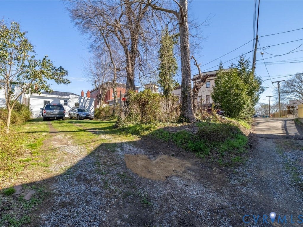 2021 Venable Street, Union Hill, Richmond, VA 23223 Gravel and grass parking area with mature trees
