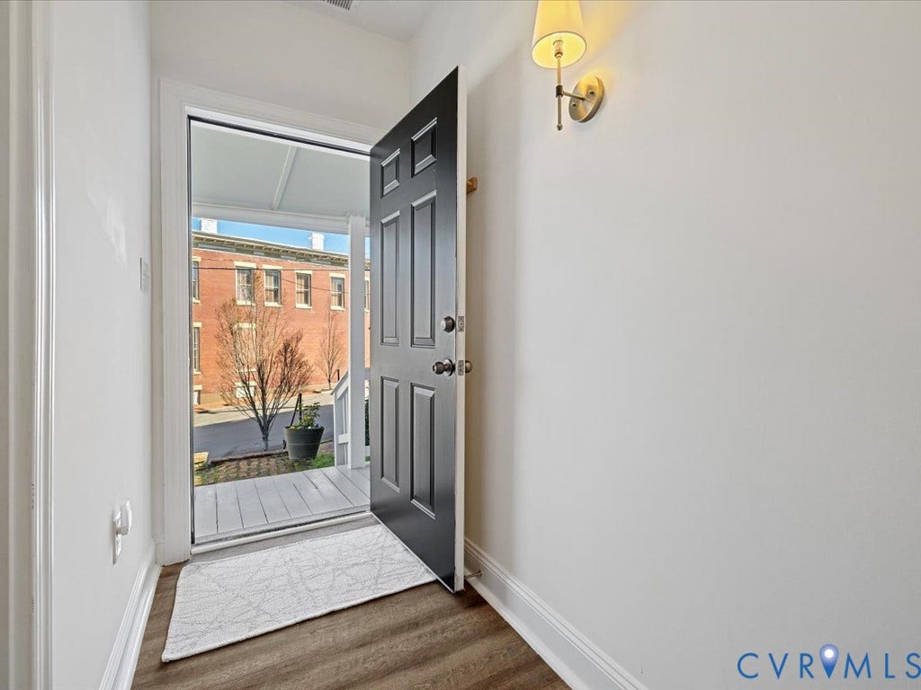 2021 Venable Street, Union Hill, Richmond, VA 23223 Entryway featuring wood-finish flooring, white walls, and a decorative wall sconce