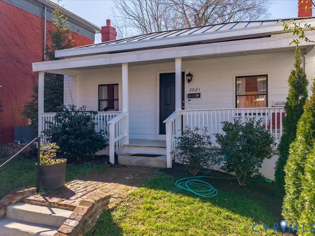 2021 Venable Street, Union Hill, Richmond, VA 23223 White exterior with a covered front porch, dark front door, metal roof, and brick steps