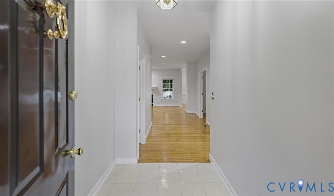 5500 Lakemere Drive, 55+ Community, North Chesterfield, VA 23234 Foyer entry with tile flooring, dark wood-finish door, and brass-tone hardware