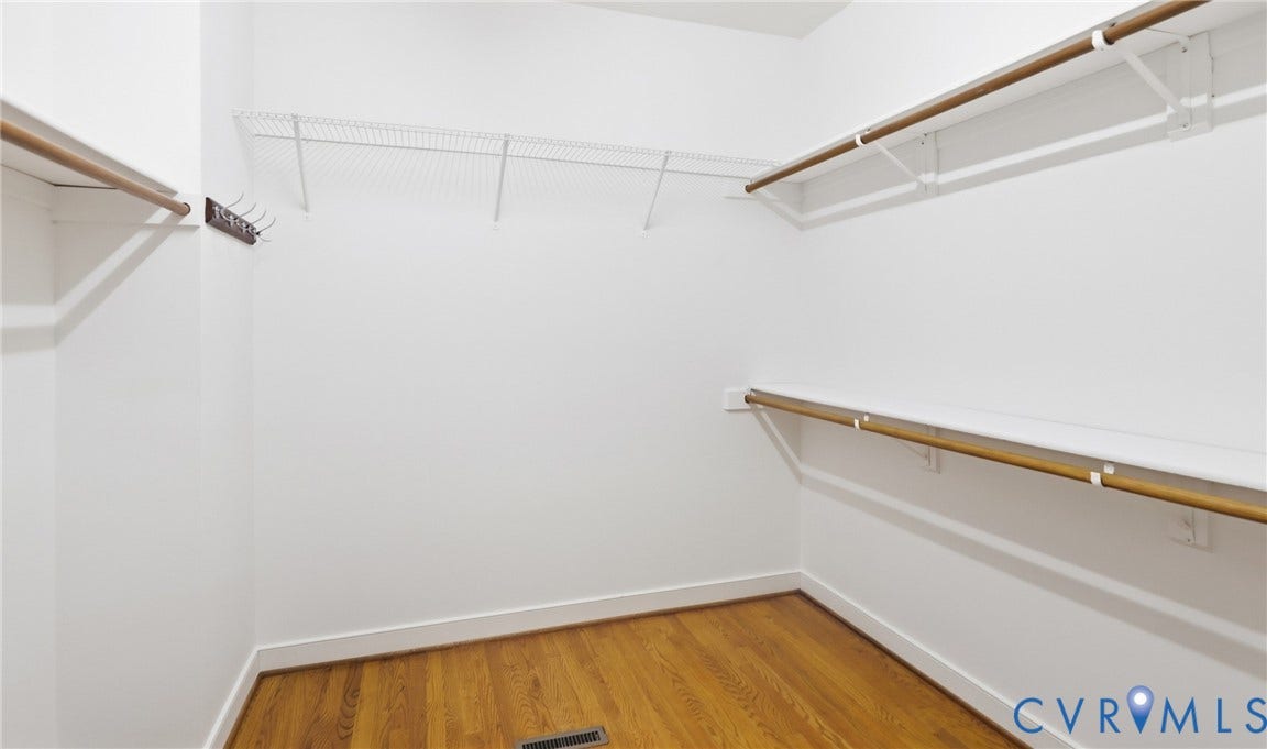 5500 Lakemere Drive, 55+ Community, North Chesterfield, VA 23234 Walk-in closet with wood-finish flooring, wire shelving, and built-in hanging rods