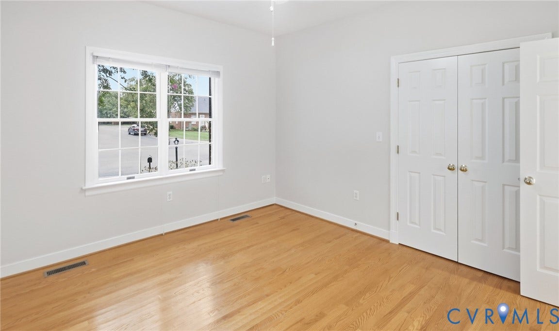 5500 Lakemere Drive, 55+ Community, North Chesterfield, VA 23234 Hardwood flooring, painted interior walls, white trim, white paneled doors, and a double-hung window