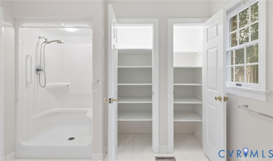 5500 Lakemere Drive, 55+ Community, North Chesterfield, VA 23234 Built-in shower with integrated seating, dual storage closets with shelving, and a multi-pane window