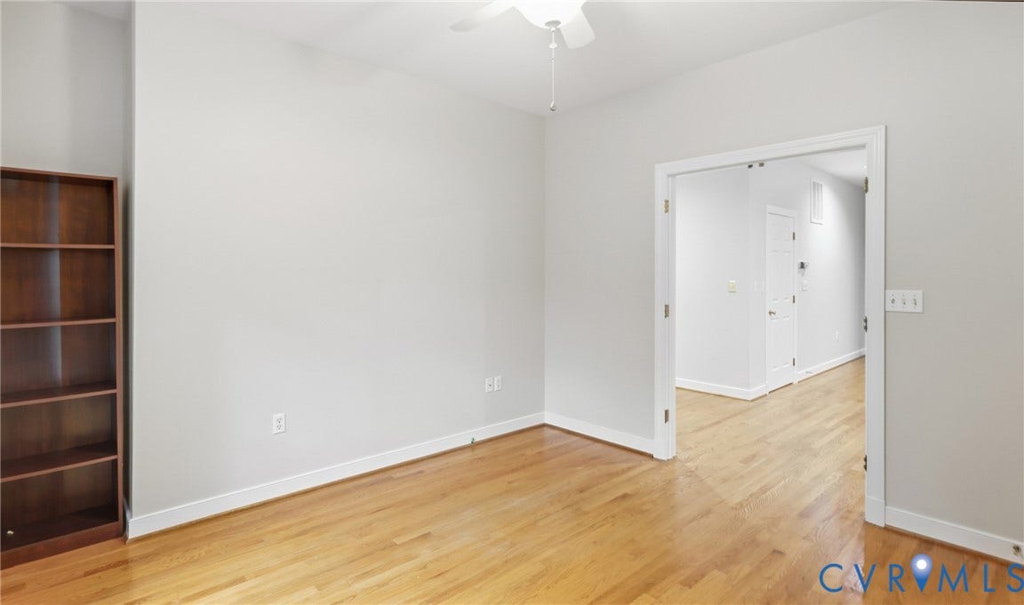 5500 Lakemere Drive, 55+ Community, North Chesterfield, VA 23234 Hardwood flooring, light gray wall finishes, white trim, built-in shelving, and a ceiling fan