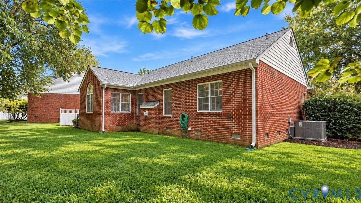 5500 Lakemere Drive, 55+ Community, North Chesterfield, VA 23234 Brick exterior with white trim, white vinyl fencing, and a manicured lawn