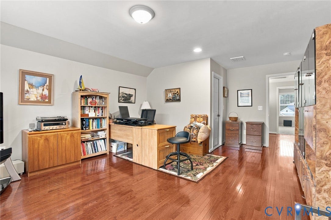 Hardwood flooring throughout, recessed lighting, and a neutral wall color