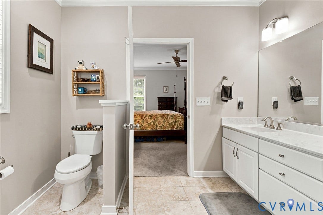 Bathroom with a single vanity featuring a countertop, integrated sink, and undermount cabinetry