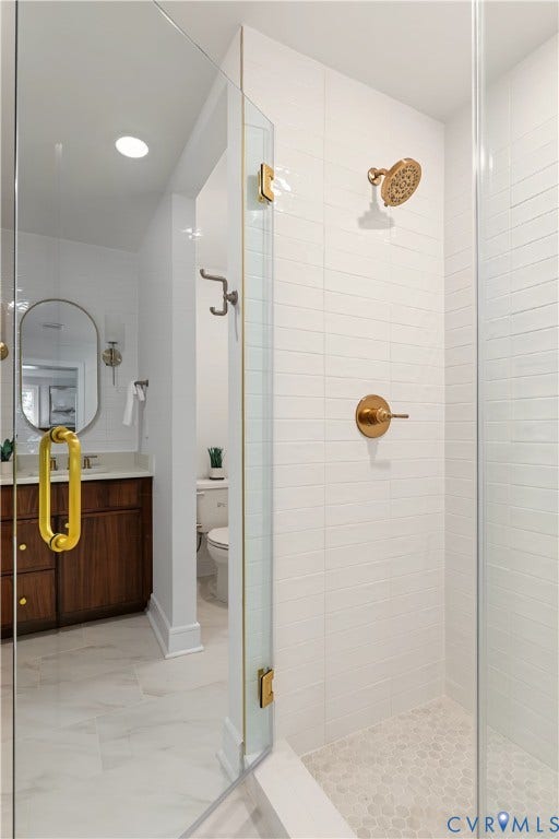 702 Westham Parkway, Westham, Henrico, VA 23229 Glass-enclosed shower with gold-tone fixtures, white tile walls, and a pebble-finish shower floor