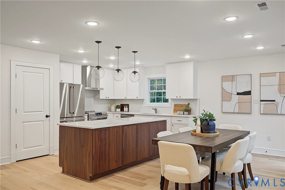 702 Westham Parkway, Westham, Henrico, VA 23229 Open-concept kitchen and dining area featuring a two-tone kitchen island with a light-toned countertop, stainless steel appliances, and wood-finish flooring