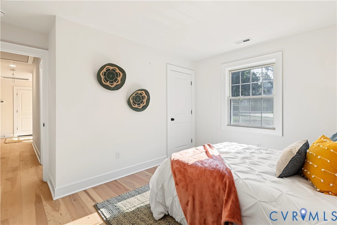702 Westham Parkway, Westham, Henrico, VA 23229 Wood-finish flooring, white paneled door, and a multi-pane window with white trim