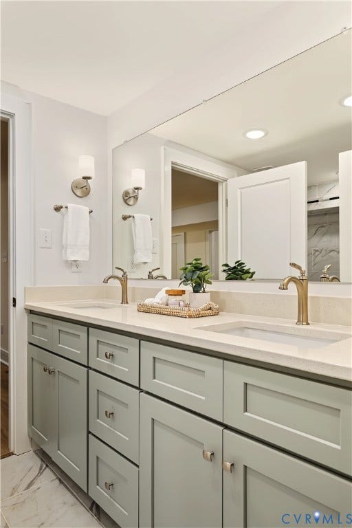 702 Westham Parkway, Westham, Henrico, VA 23229 Dual vanity with a light-toned countertop, two integrated sinks, and brass-finish faucets