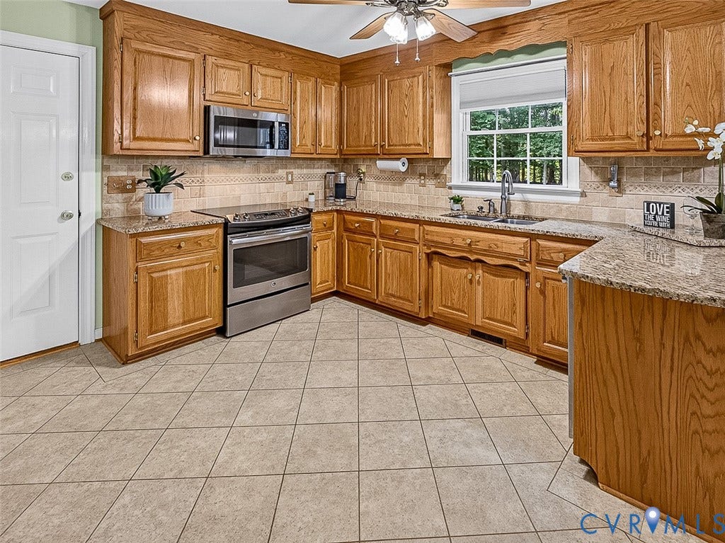 4013 Tweedsmuir Road, Moseley, VA 23120 kitchen pairs warm wood cabinetry with generous counter space