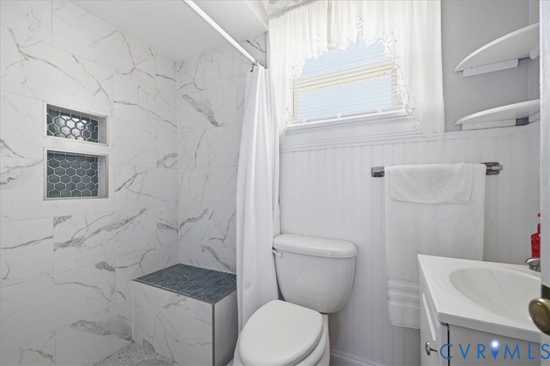 216 Conduit Road, Riverside Park, Colonial Heights, VA 23834 Walk-in shower with marble-look tile, built-in shelving, and tiled bench