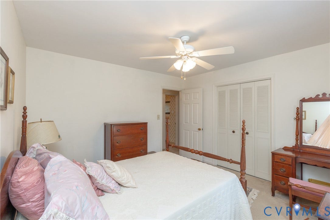 3640 Kiefer Road, Chester, VA 23831 White walls, ceiling fan with light, white bi-fold closet doors, and light-colored carpet flooring