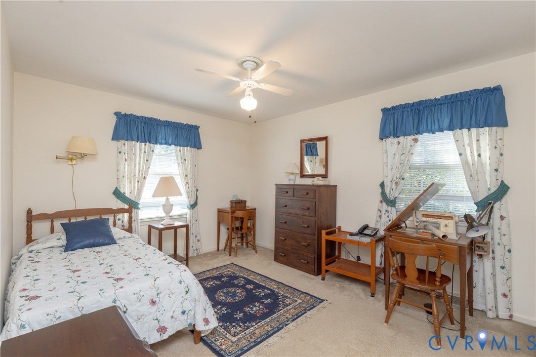 3640 Kiefer Road, Chester, VA 23831 Neutral wall color with two windows, a ceiling fan, and carpeted flooring
