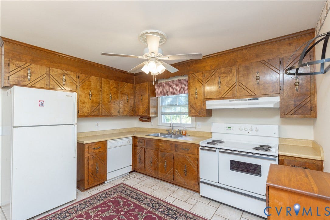 3640 Kiefer Road, Chester, VA 23831 U-shaped kitchen with wood-finish cabinetry, tile flooring, ceiling fan, and white appliances including a refrigerator, dishwasher, and electric range