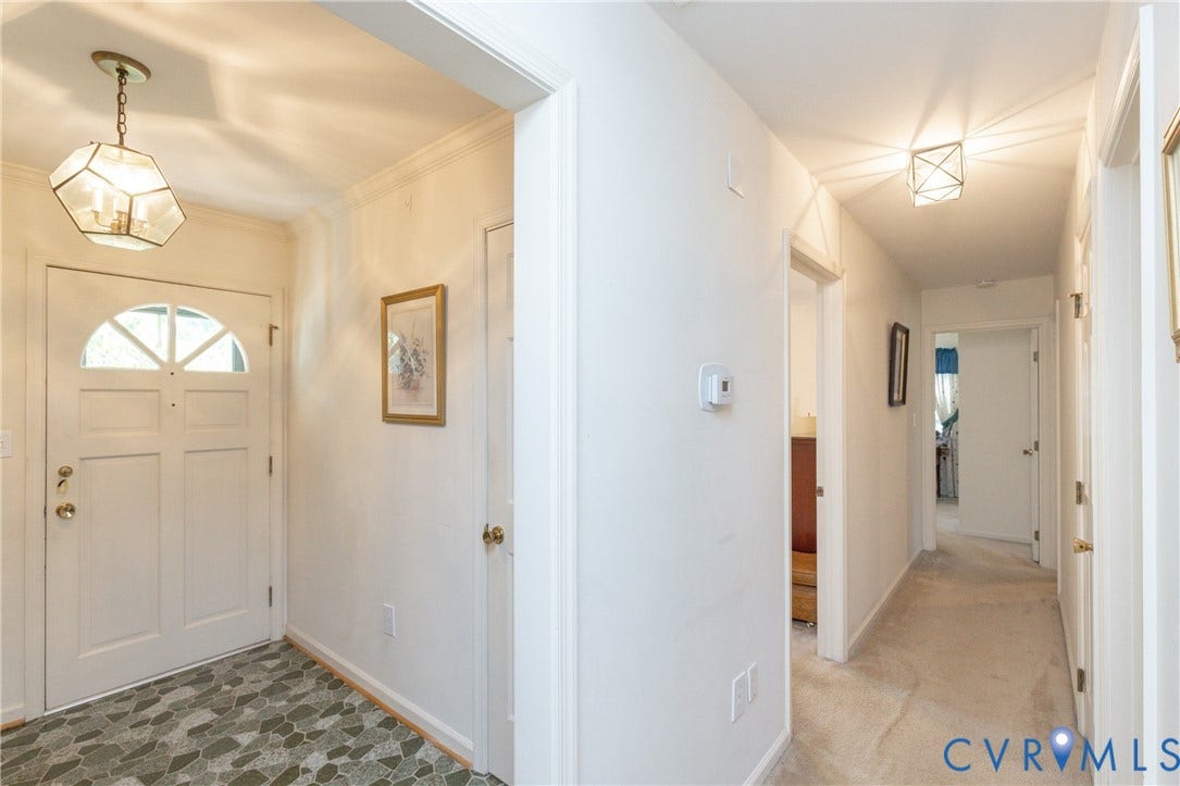3640 Kiefer Road, Chester, VA 23831 Entryway featuring a decorative transom door, geometric pendant lighting, and patterned flooring