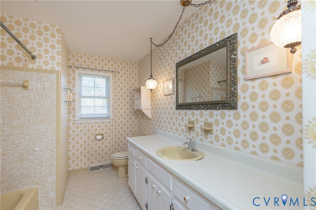 3640 Kiefer Road, Chester, VA 23831 Vanity with ample counter space, built-in storage cabinetry, and a framed wall mirror
