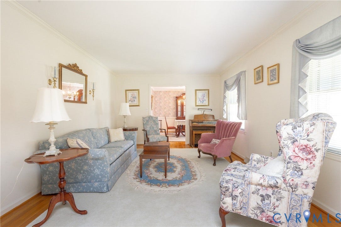 3640 Kiefer Road, Chester, VA 23831 Carpeted living space with crown molding, hardwood flooring, and window treatments