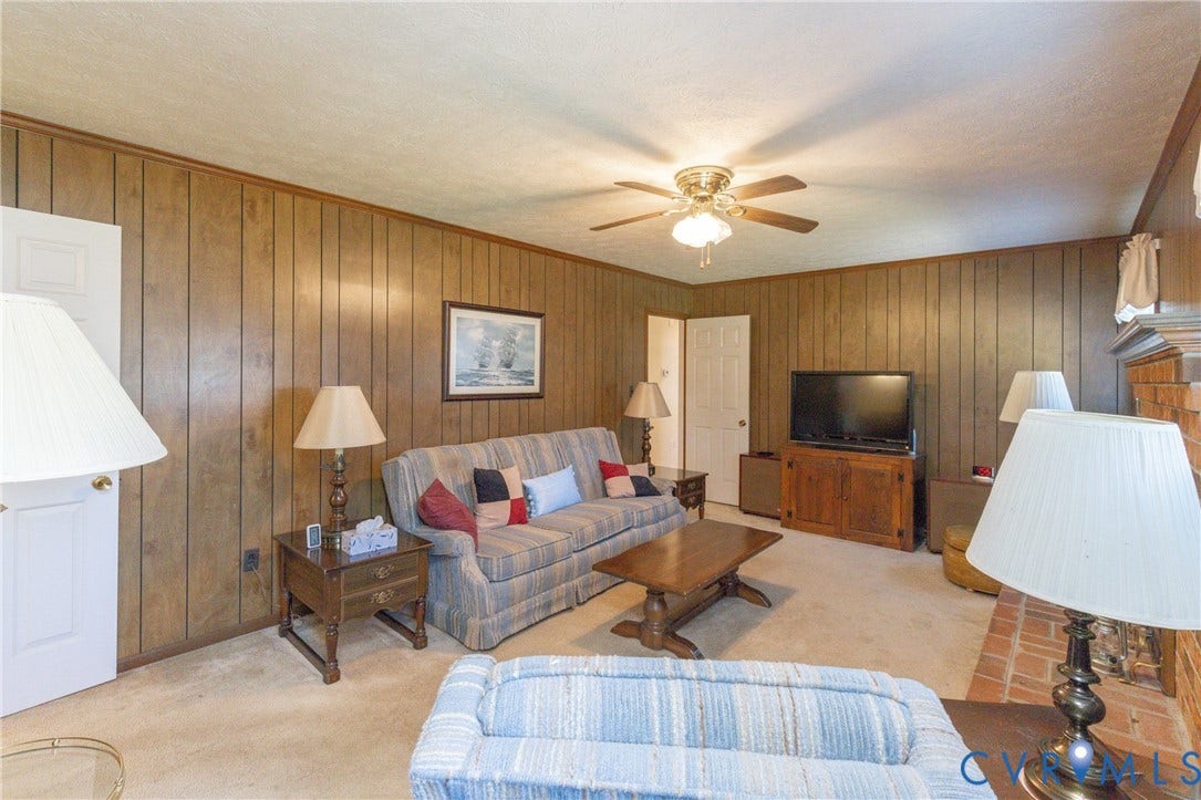 3640 Kiefer Road, Chester, VA 23831 Wood-panel wall finishes and a ceiling fan with integrated lighting
