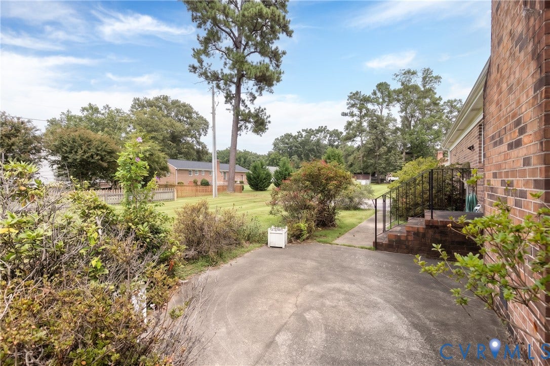 3640 Kiefer Road, Chester, VA 23831 Brick exterior with a side entry, paved driveway, and mature landscaping