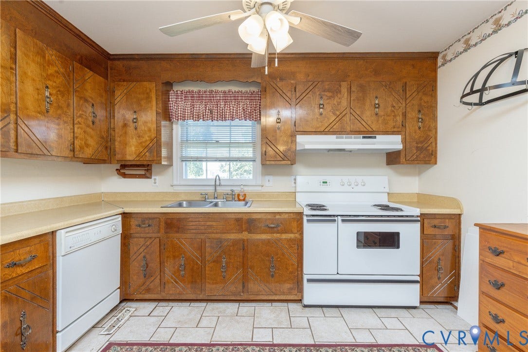 3640 Kiefer Road, Chester, VA 23831 Wood-finish cabinetry with decorative panels, white appliances, and a stainless steel sink