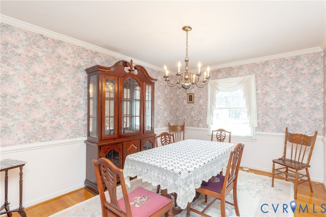 3640 Kiefer Road, Chester, VA 23831 Hardwood flooring, decorative wallpaper, crown molding, chair rail, and a brass chandelier